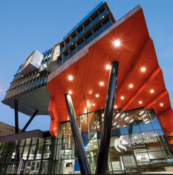 A modern architectural marvel, the University of Newcastle stands tall, showcasing its sleek design of metal and glass.